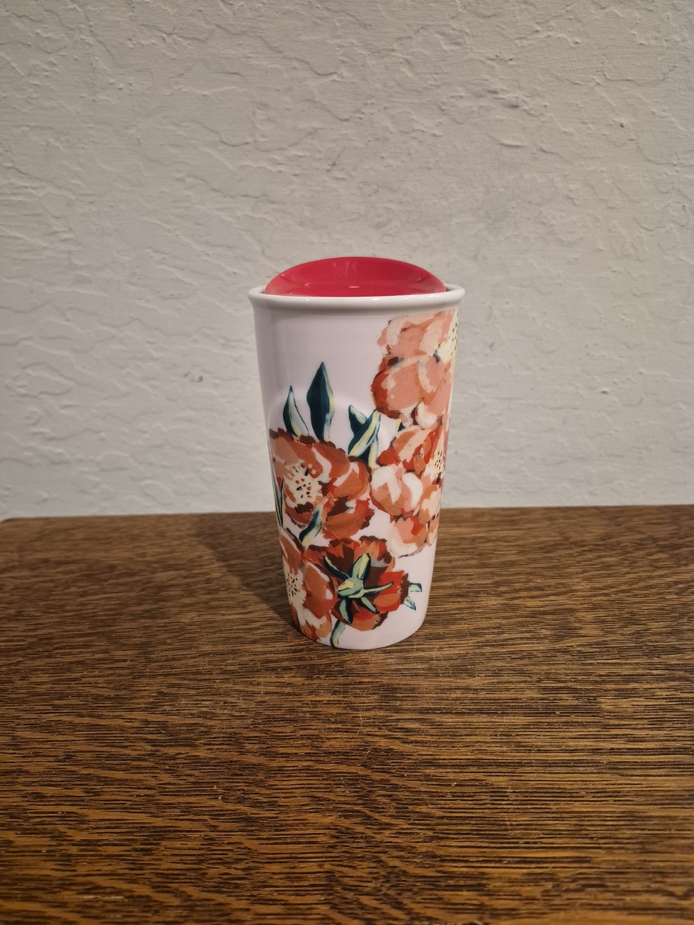 Collectible Starbucks 2015 floral ceramic travel mug with a red lid 10oz